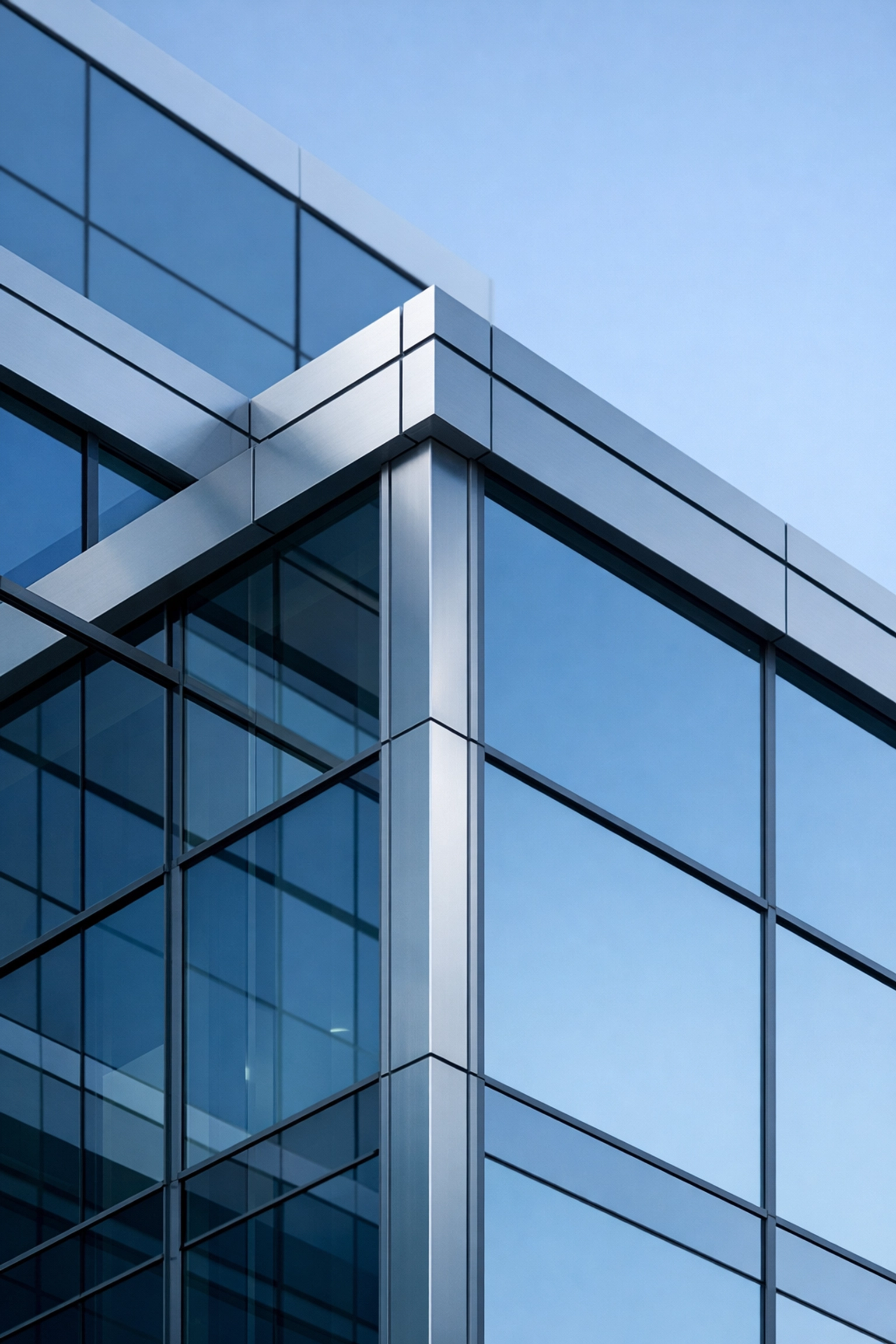 Modern glass corporate building in Alabama reflecting stable business foundations and market value.