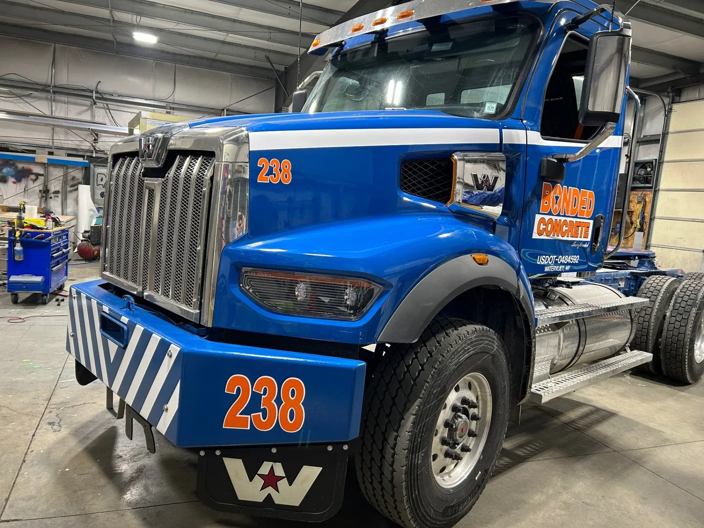 Custom vehicle graphics and lettering installed on a blue Bonded Concrete truck