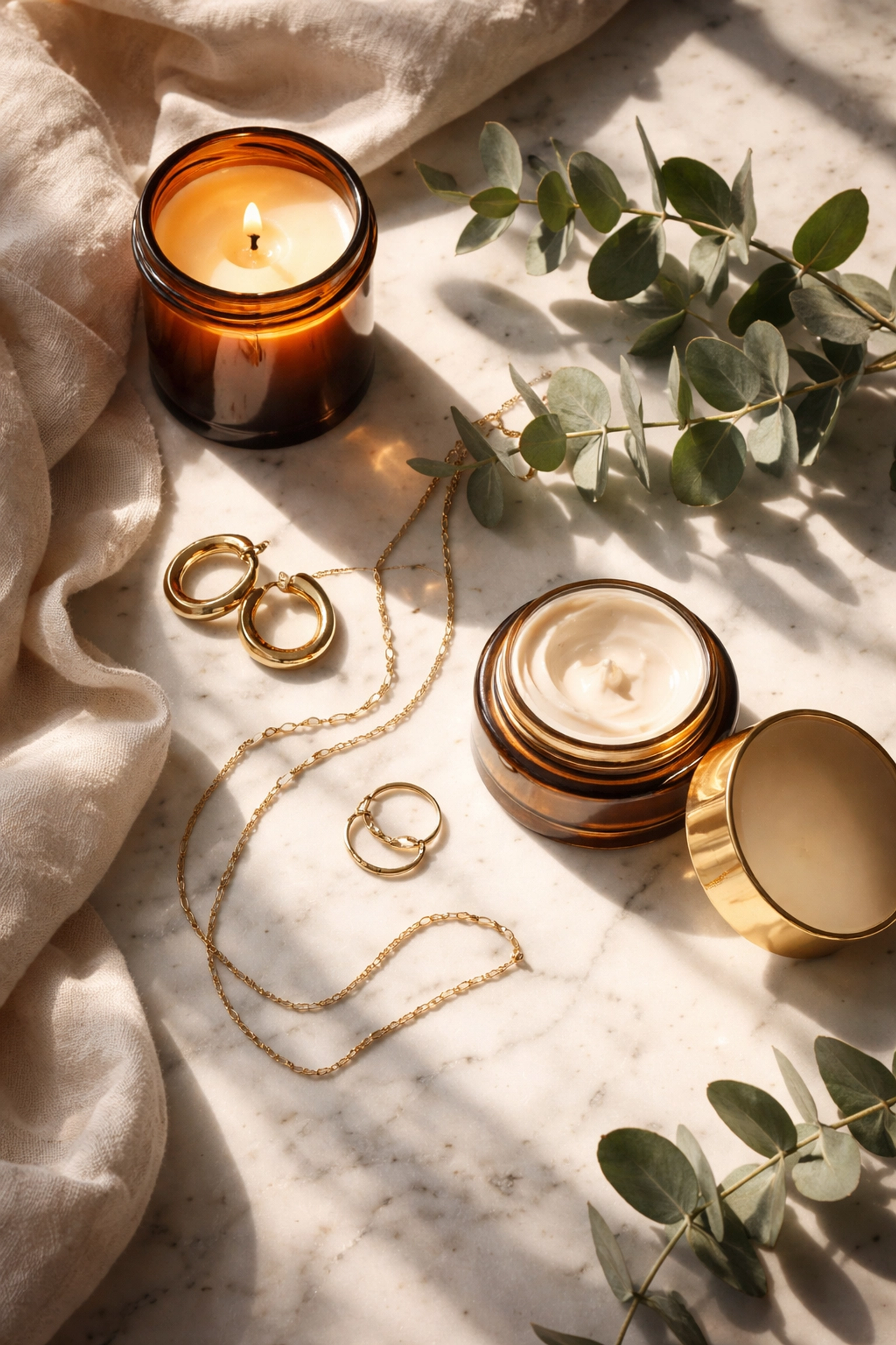Black Wall Street's Legacy Matters: How to Buy Black and Build Community Wealth Today Luxurious self-care products from Black-owned brands, including candles and jewelry, on white marble