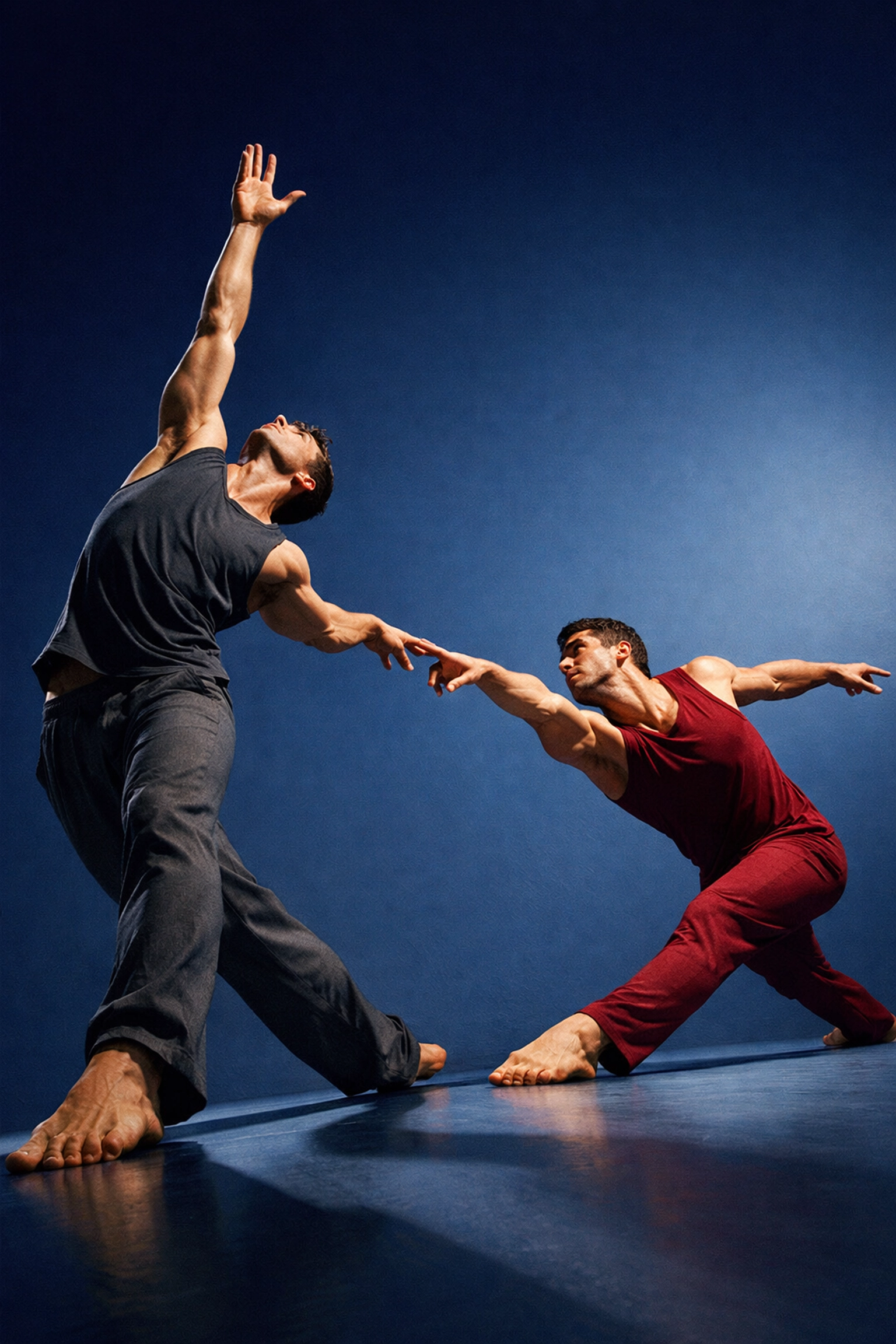 Male modern dancers reaching toward each other in powerful movement celebrating LGBTQ+ dance artistry
