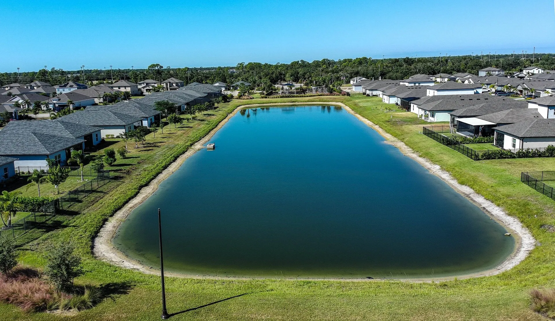 High-resolution aerial image of a residential neighborhood with lake