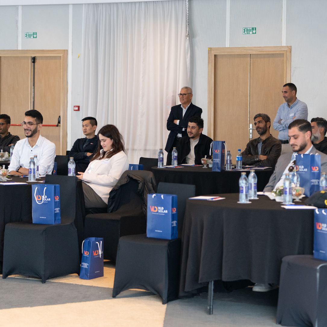 VLD SOLAR team members and partners attending a professional seminar with branded bags and notebooks on tables