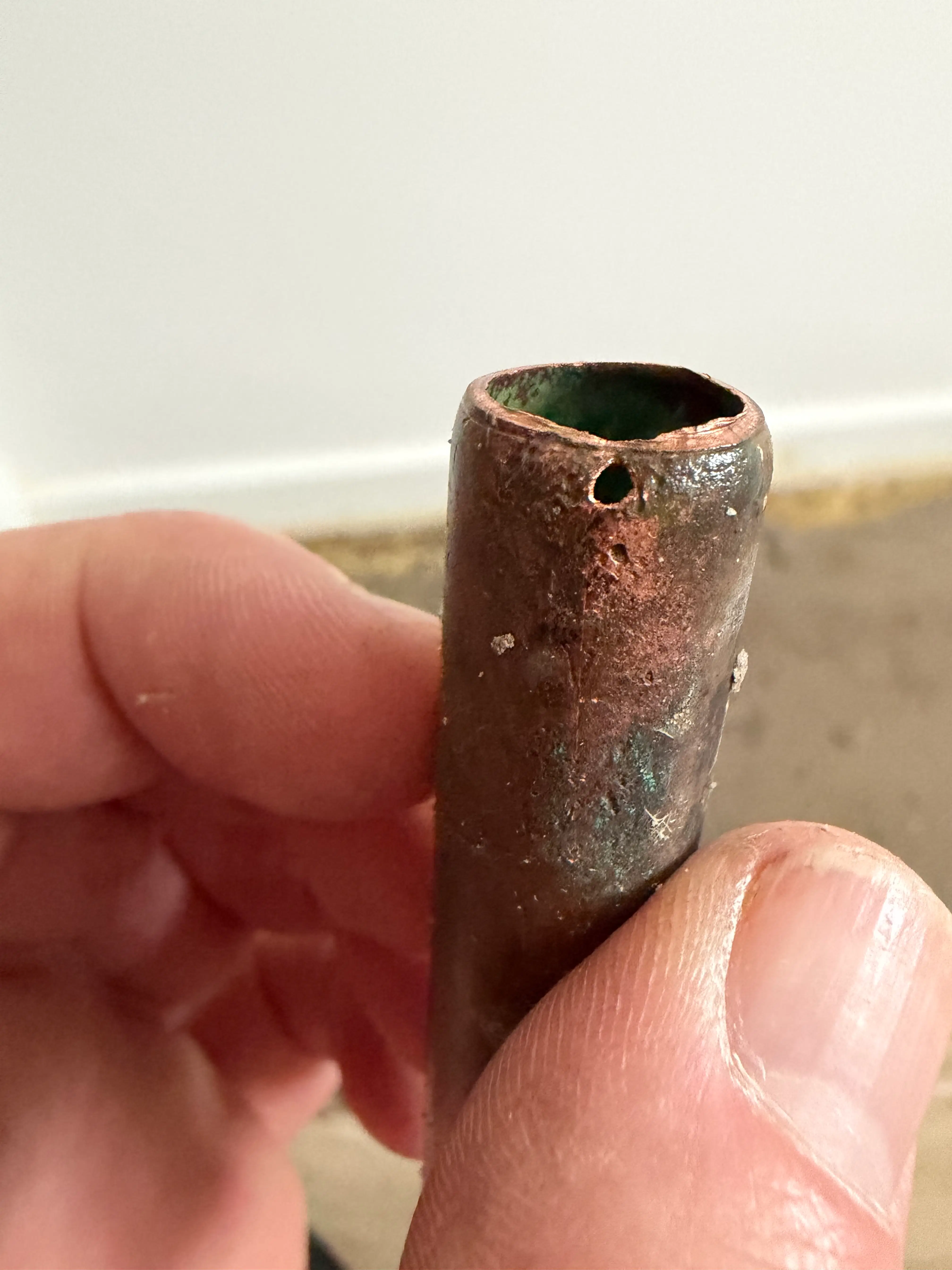 Real Aldershot job photo: close-up of the pinhole leak on the water main pipework