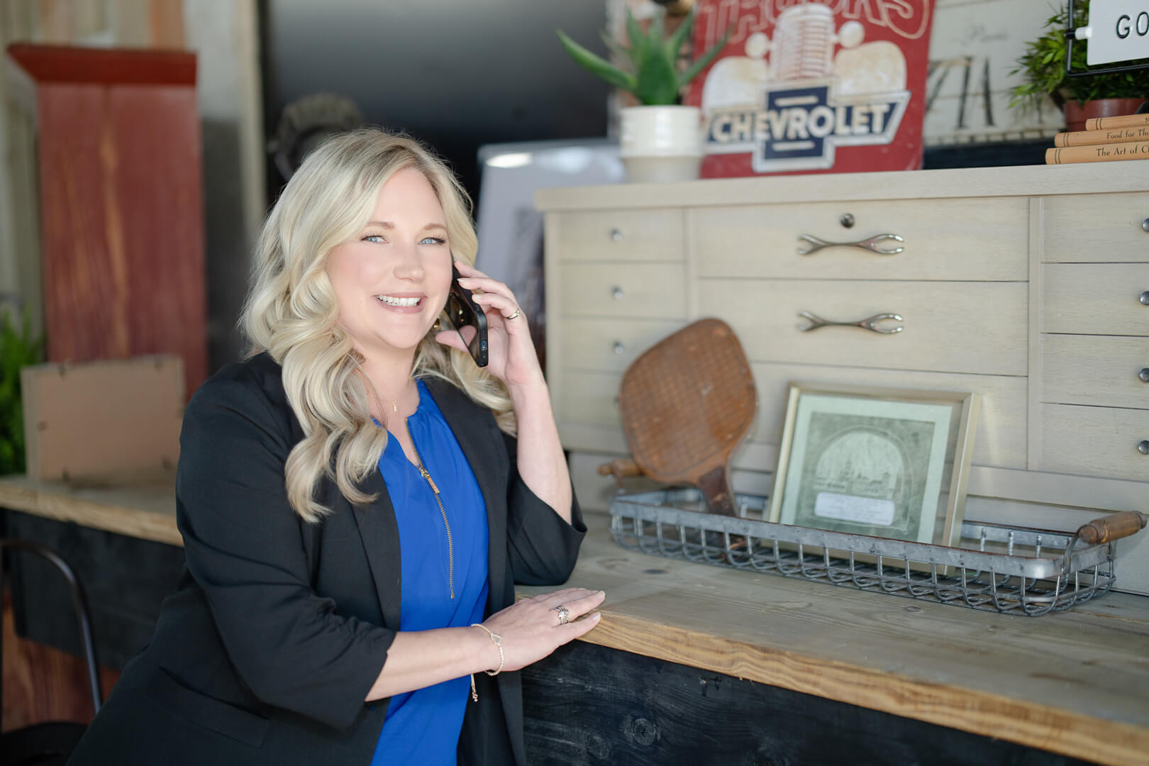 A professional woman with blonde hair talking on the phone