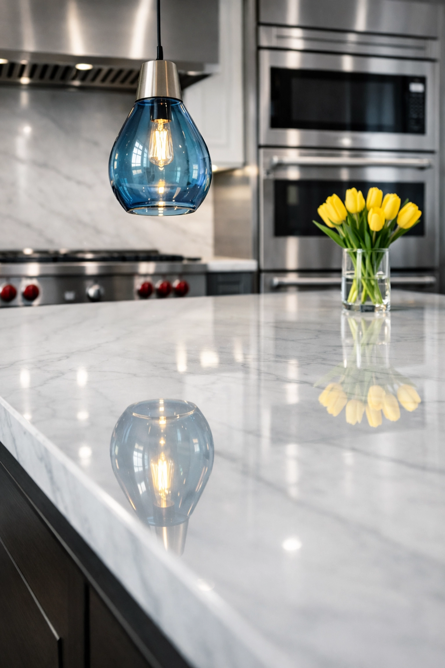 Shiny marble kitchen island and clean appliances after professional house cleaning in Wellesley.