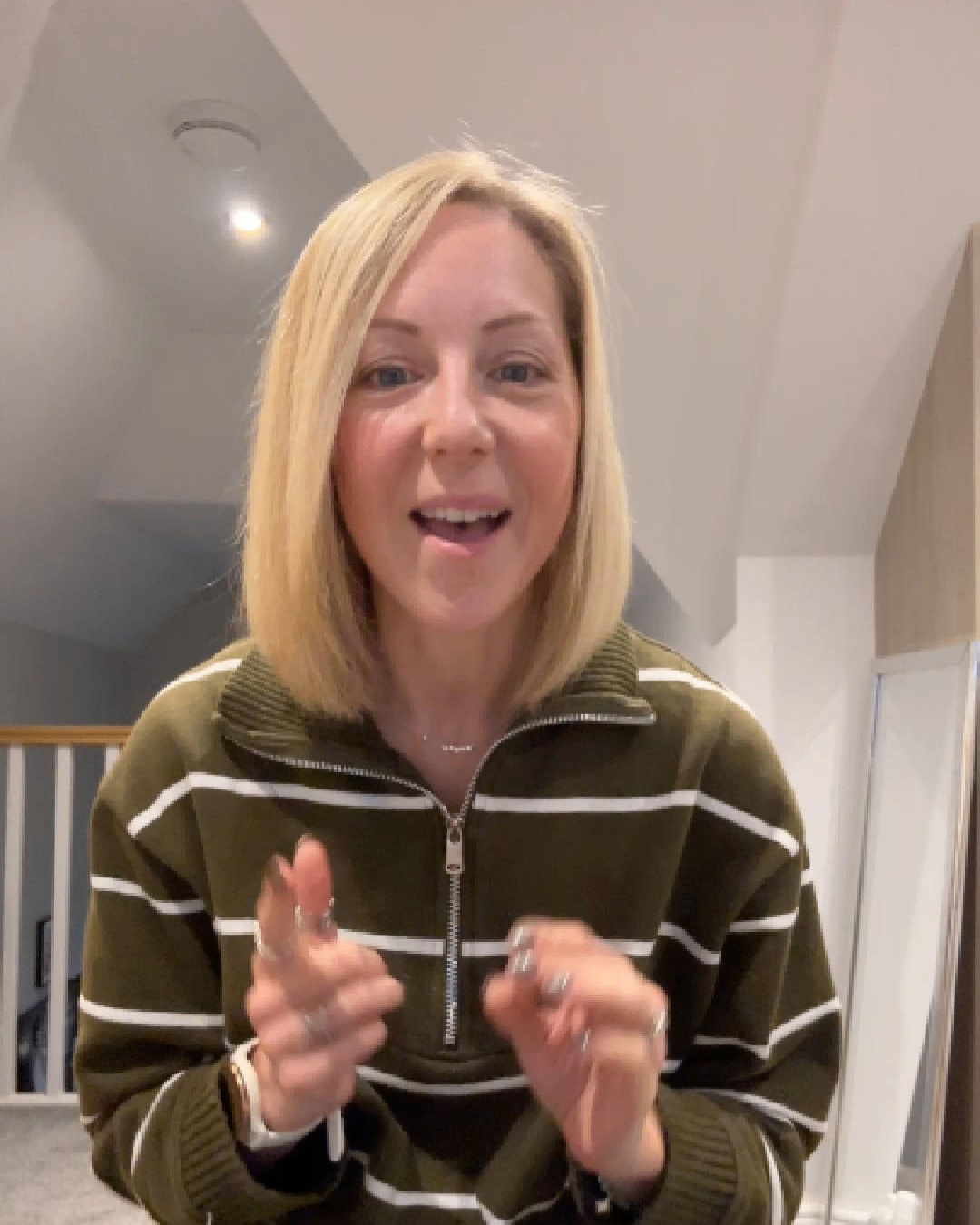 Smiling woman with blonde hair recording a video Smiling woman with blonde hair recording a video