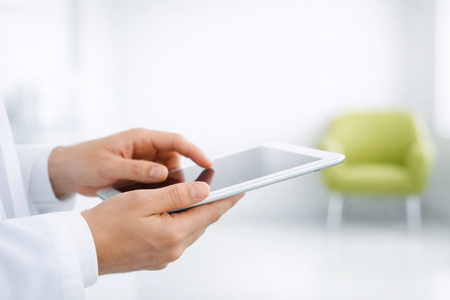 Medical clinic staff using a tablet to process digital patient intake forms and automate admin tasks.