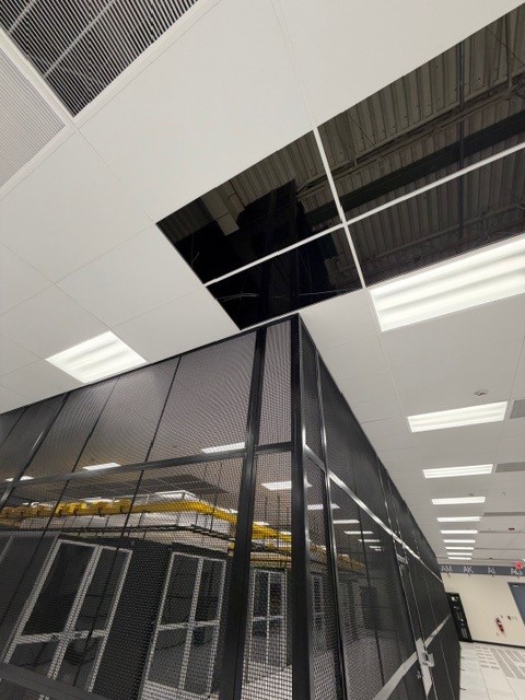 High-security, modular data center cage constructed with black powder-coated steel mesh panels.
