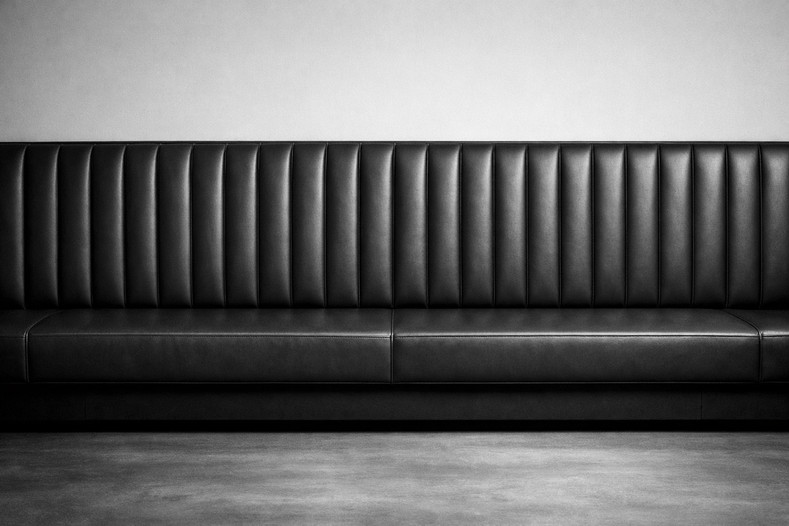 Sleek charcoal grey restaurant banquette seating custom upholstered for a Chattanooga business.