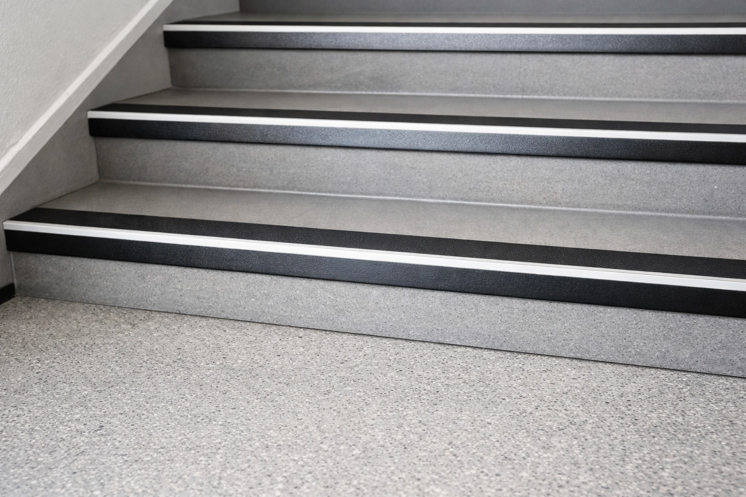 High-contrast strips on the edges of stair steps to improve visibility and depth perception for seniors.
