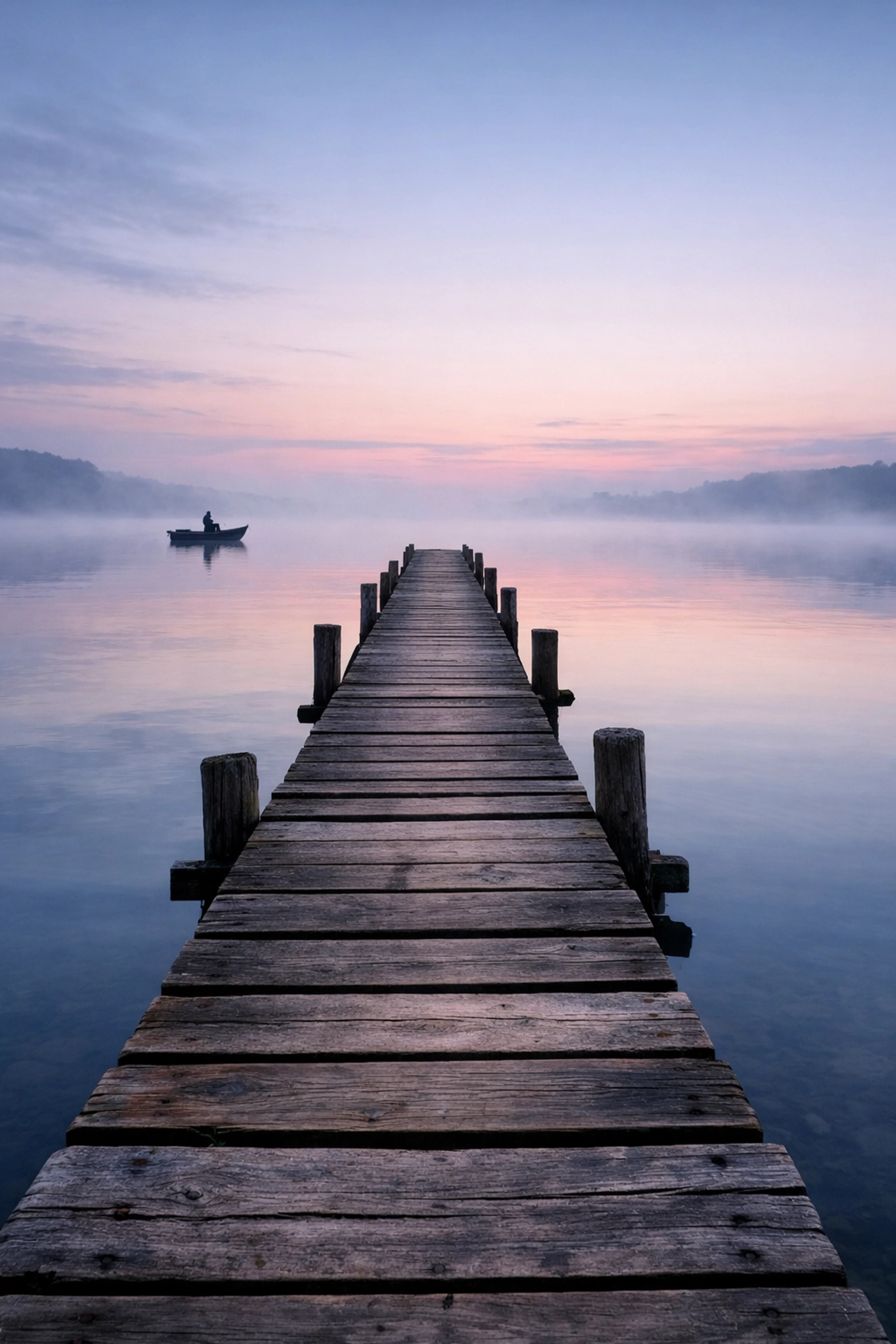 A misty lake landscape using leading lines and the rule of thirds for better photography composition.