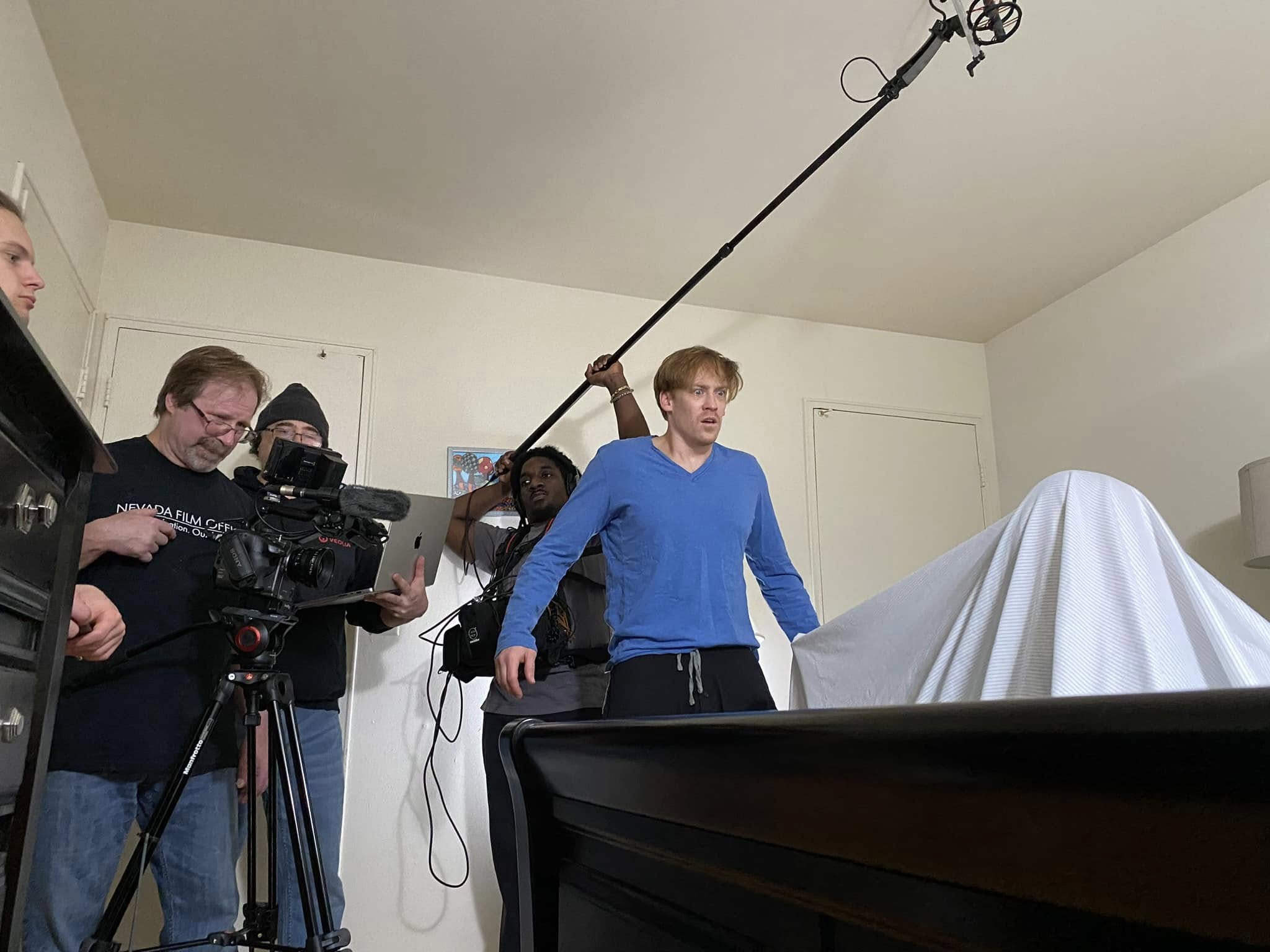 Film crew operates camera and boom microphone during dramatic scene