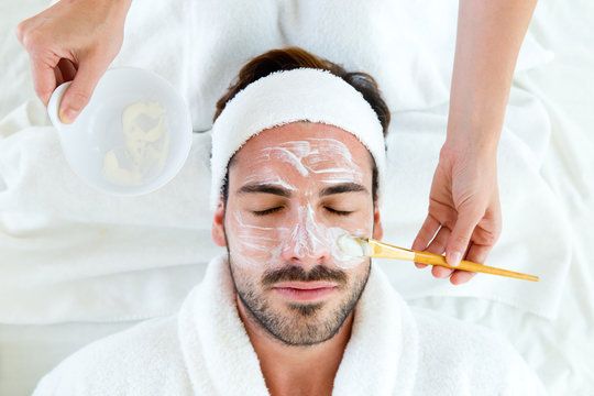 A man is receiving a professional facial treatment at BodyBrite Cooper City, illustrating personalized skincare for men.