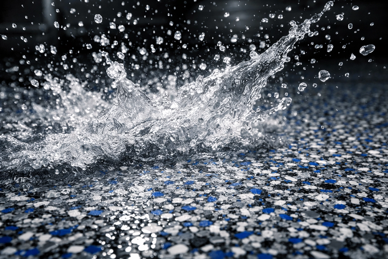 Slip-resistant polymer flake garage floor with water demonstrating safety features