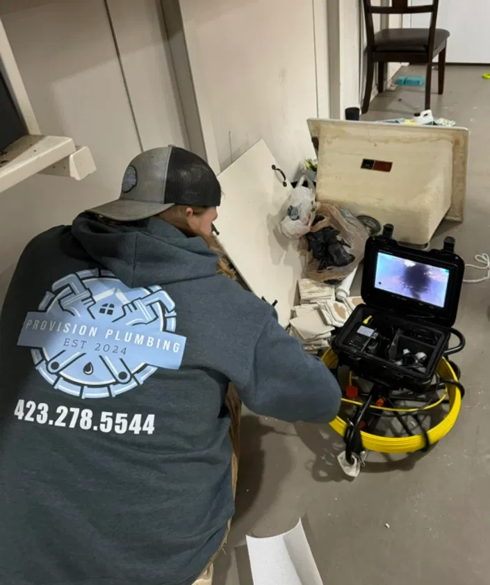 Provision Plumbing technician uses a pipe inspection camera to diagnose a sewer line issue