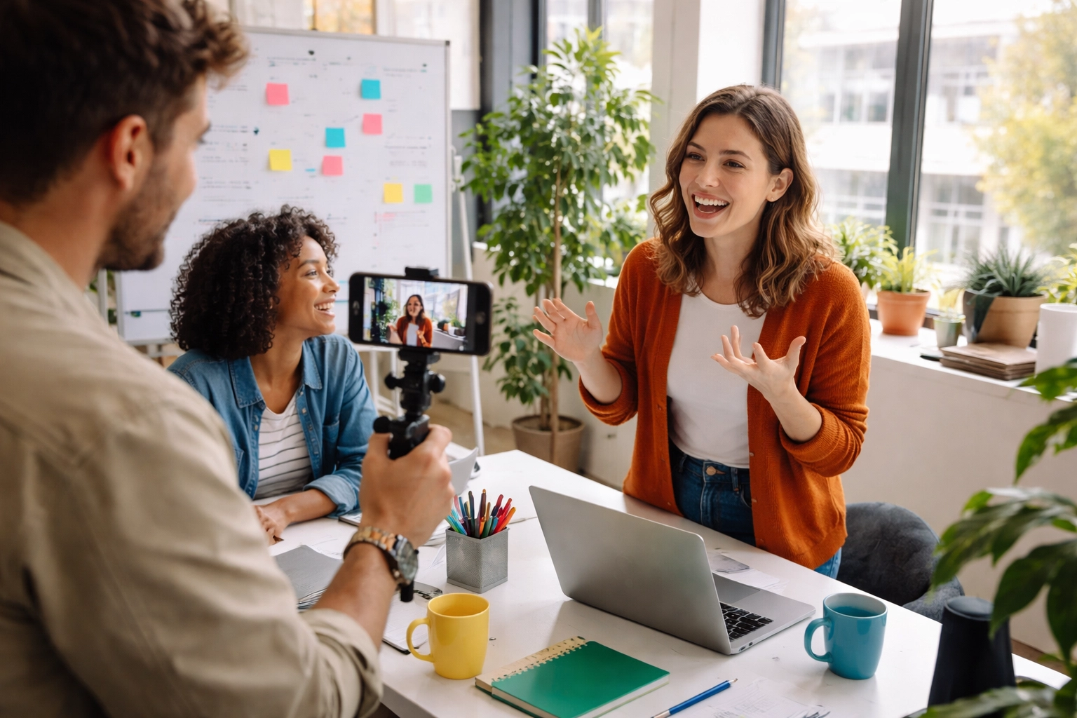 Creative team films behind-the-scenes video in a bright office, building trust and authenticity for their business.