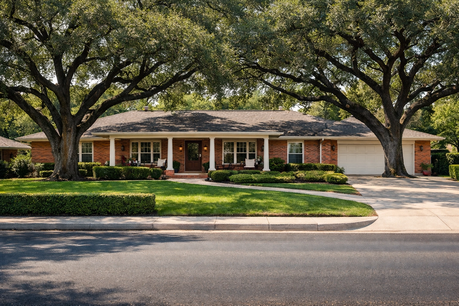 Established mid-century ranch-style house in Windcrest San Antonio with large oak trees and a green lawn.
