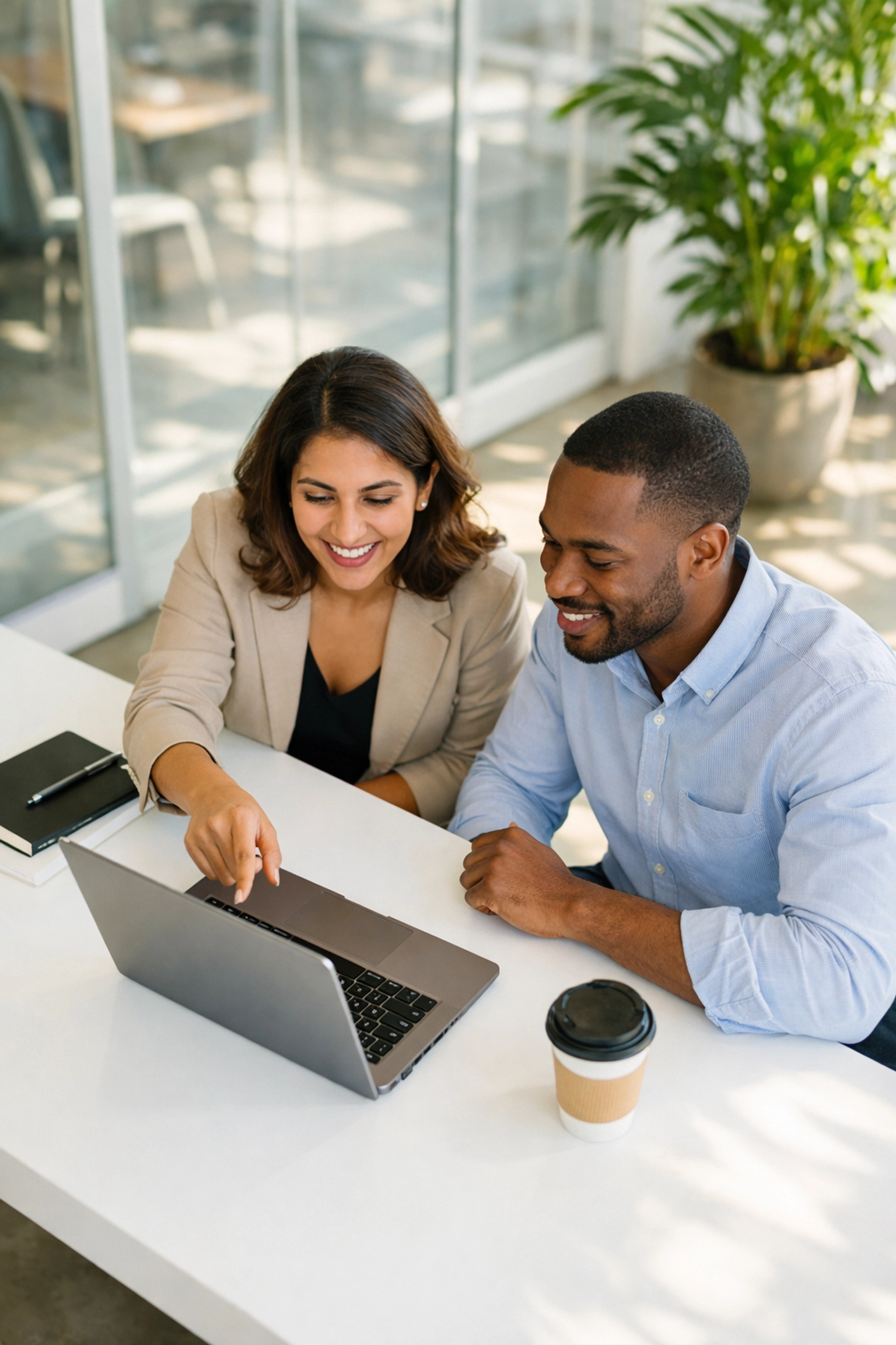 Professionals collaborating on ServiceNow ITOM and ITAM strategies in a modern, sun-drenched office.