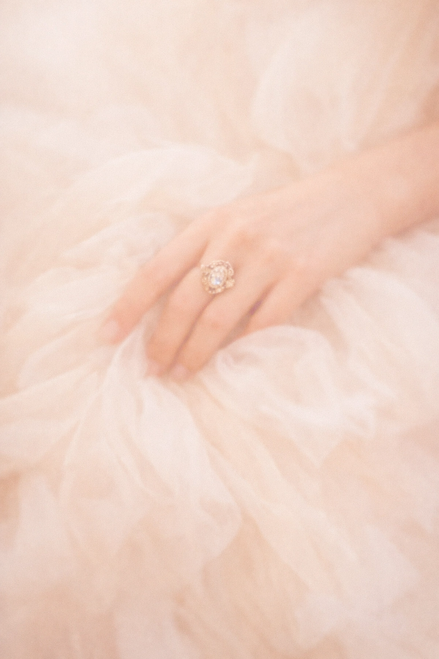 Romantic close-up of soft silk tulle and luxury bridal fabric layers for a historic wedding.