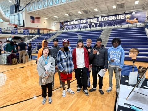 Hamilton HS Career Fair - Group Photo 1 Group of students in the Hamilton HS gym with 'Home of the Big Blue' bleachers.