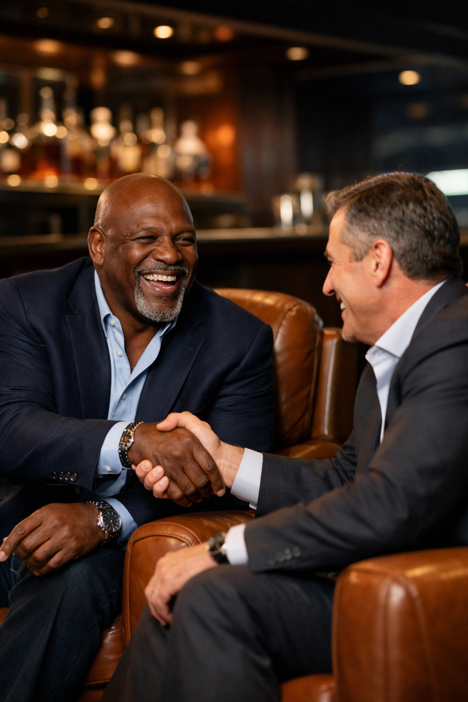 NFL legend shaking hands with a corporate executive during a Super Bowl VIP hospitality event.