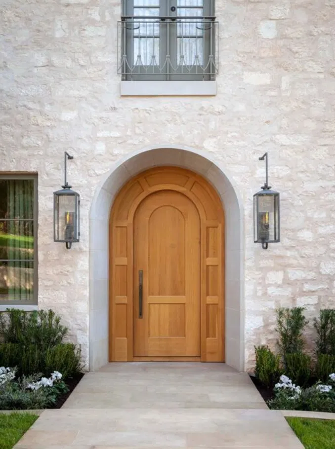 A perfectly refinished mahogany arched door, a primary focus of our Annual Wood Preservation program.