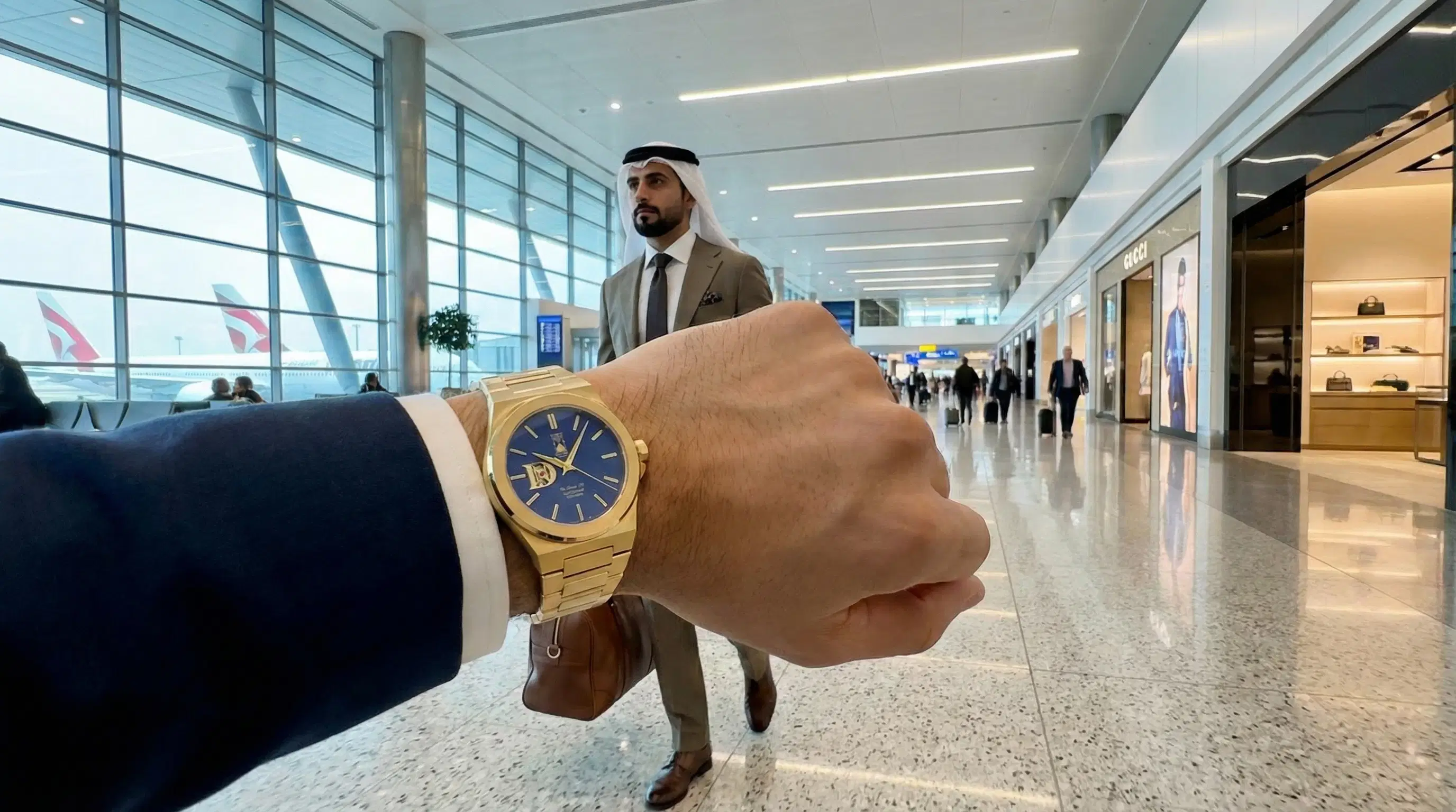 Gold traveler watch in an airport setting