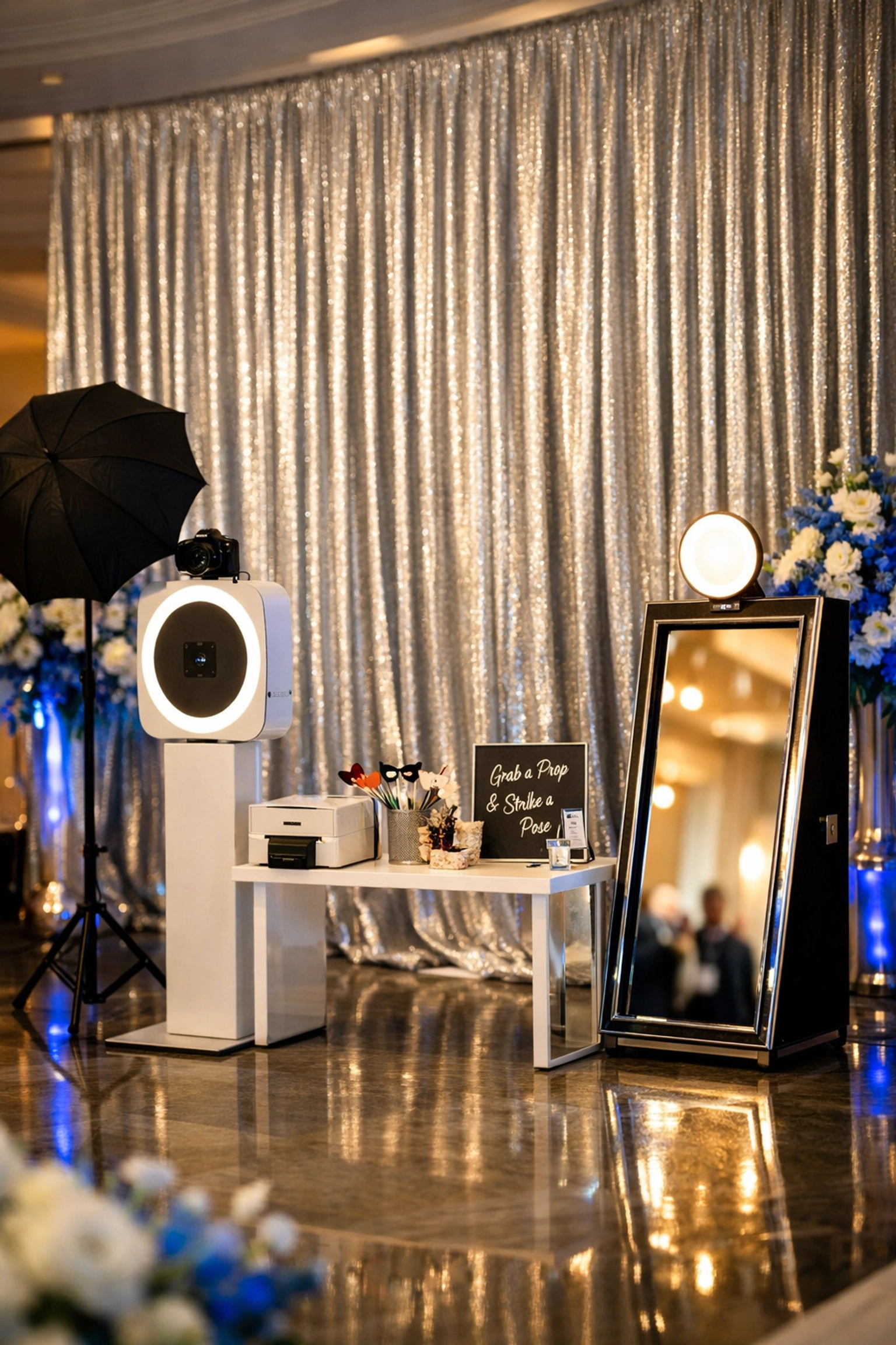 Shimmering silver wedding backdrop rental with electric blue accents for a modern 2026 reception.
