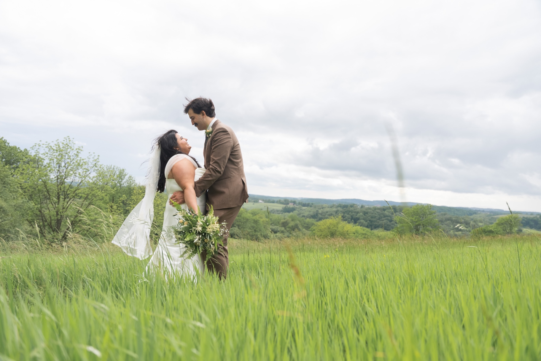 A bride and groom in an open field