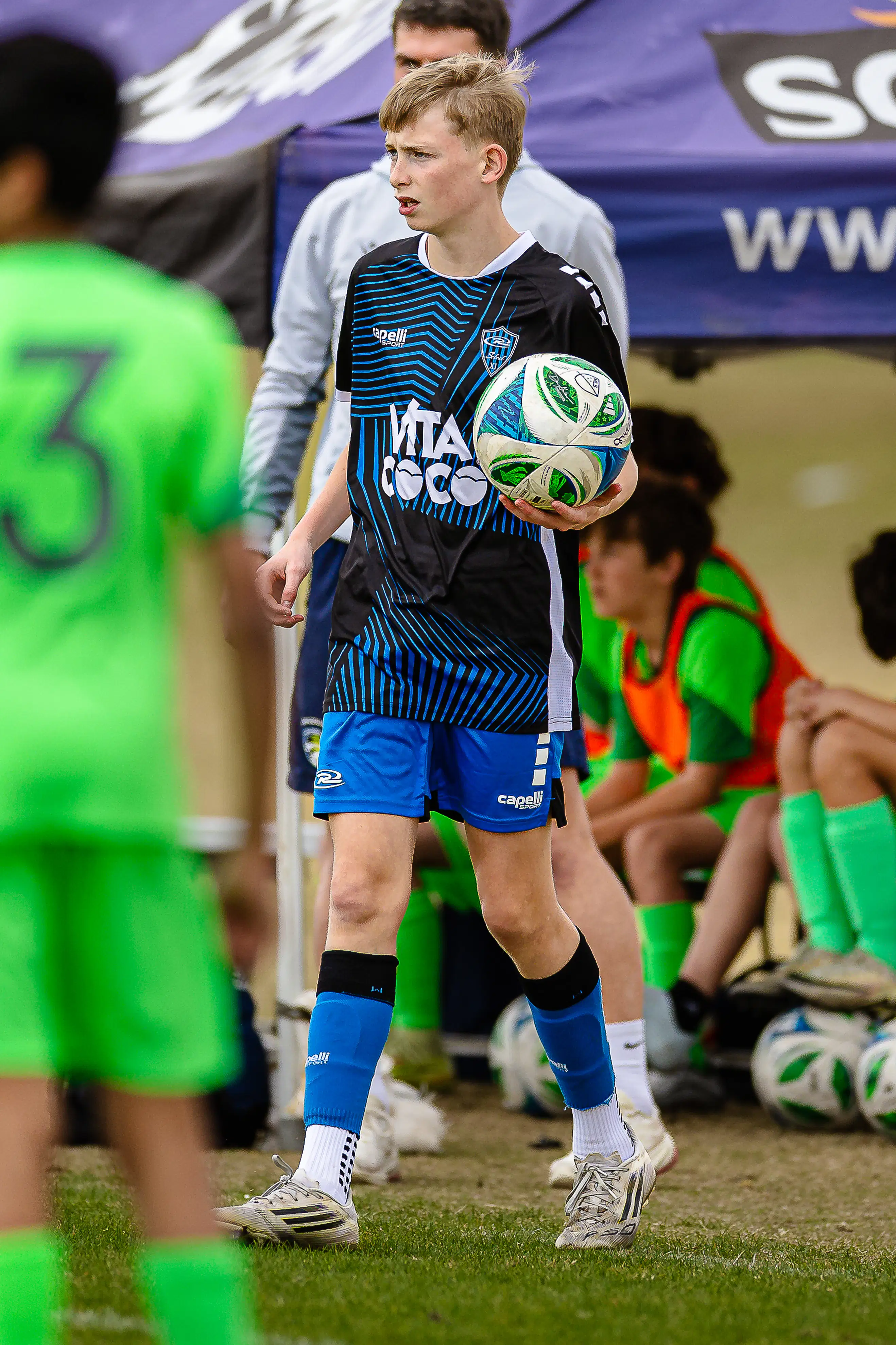 Beyond the play: A youth soccer player prepares for a throw-in, capturing the atmosphere and intensity of the high school game.