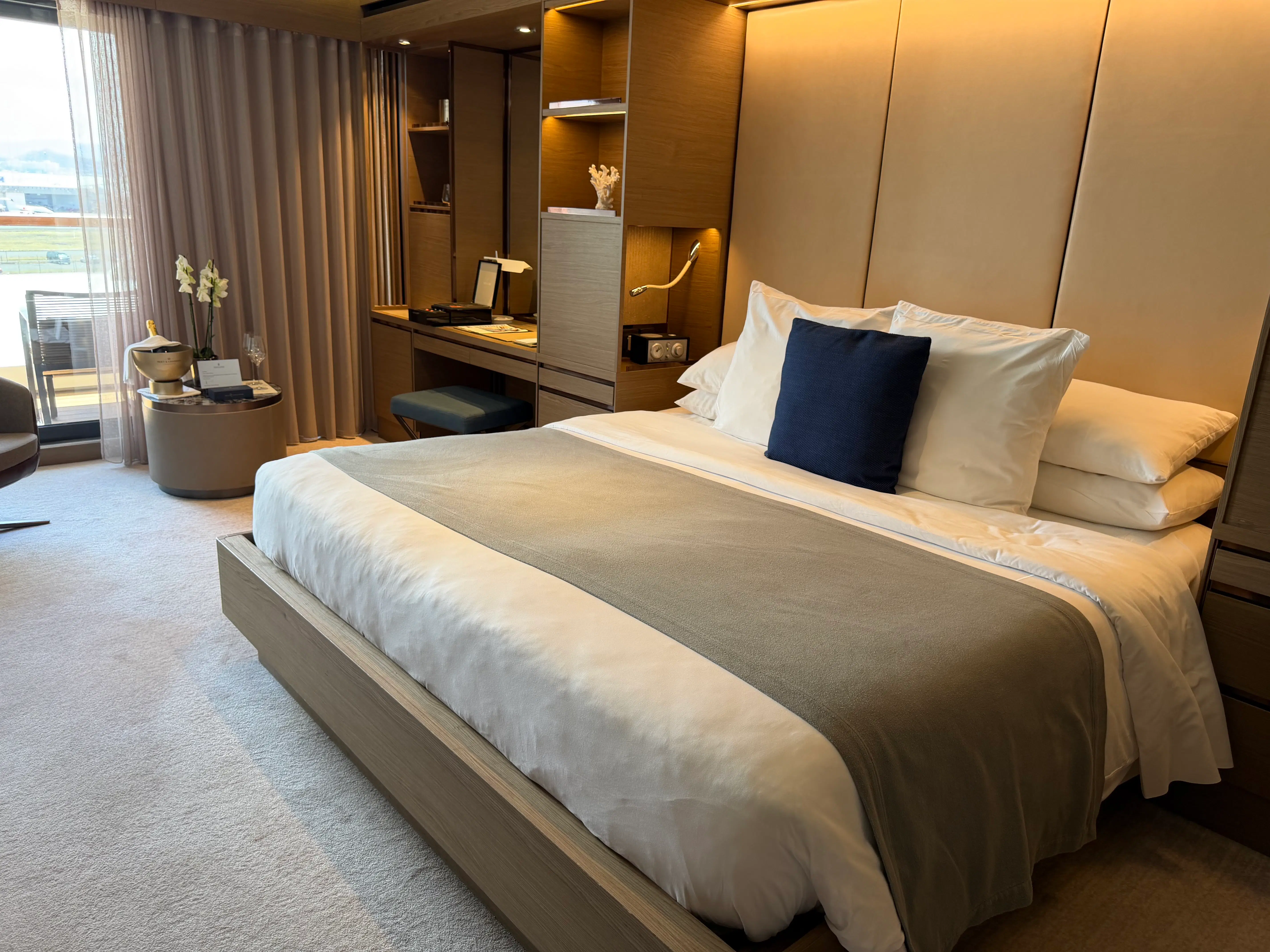 a bed with a headboard and a shelf in a room