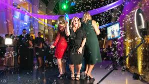 Three women at photo booth by The Weathered Moose LLC