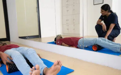 Patient using a foam roller under therapist supervision