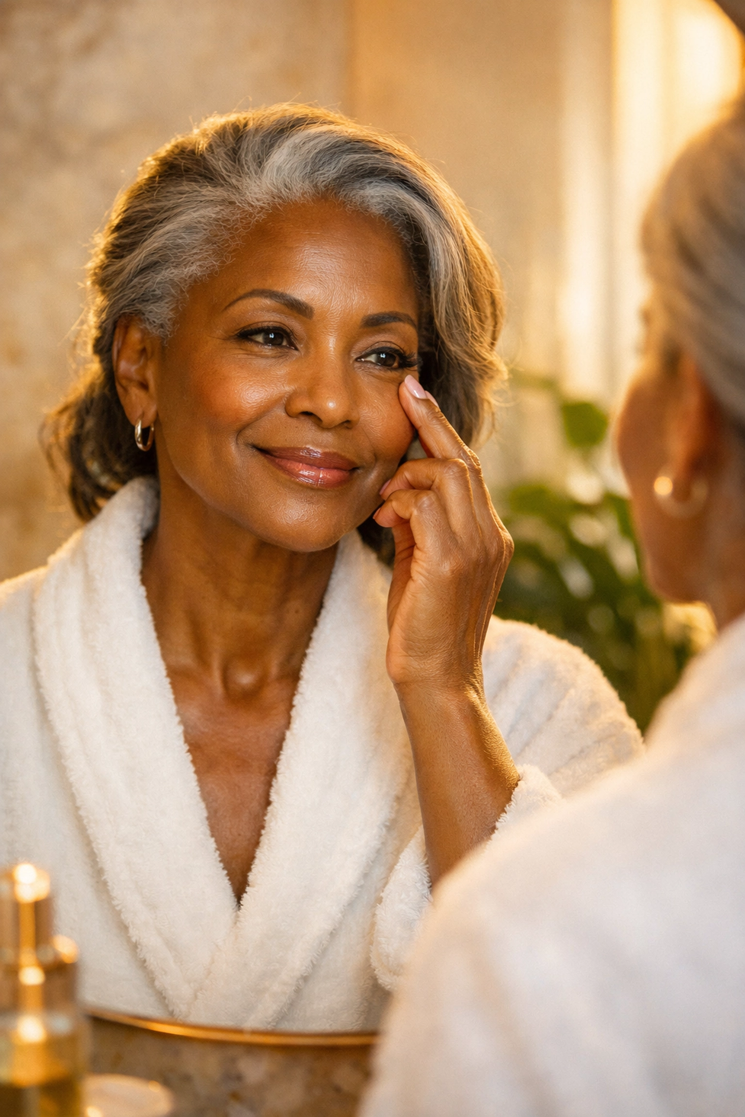 Mature Black woman gently massaging her under-eye area as part of an anti-aging skincare routine for healthy skin.