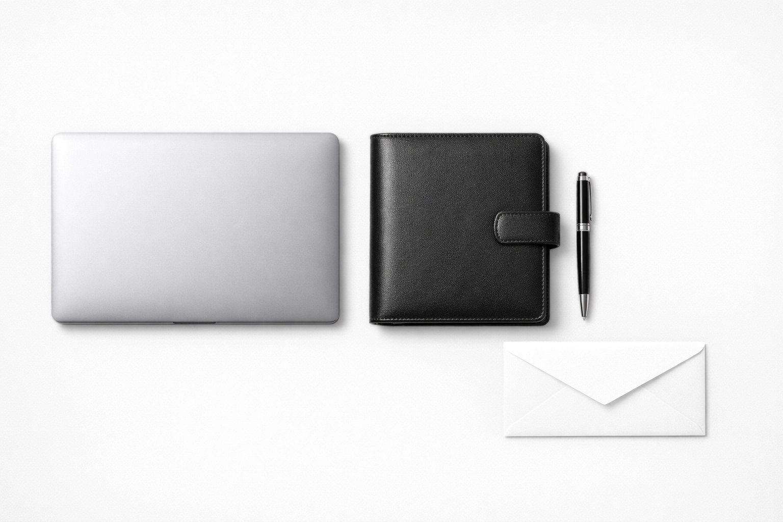 Organized desk with a laptop and white envelope, representing the checklist for S-Corp business tax preparation.