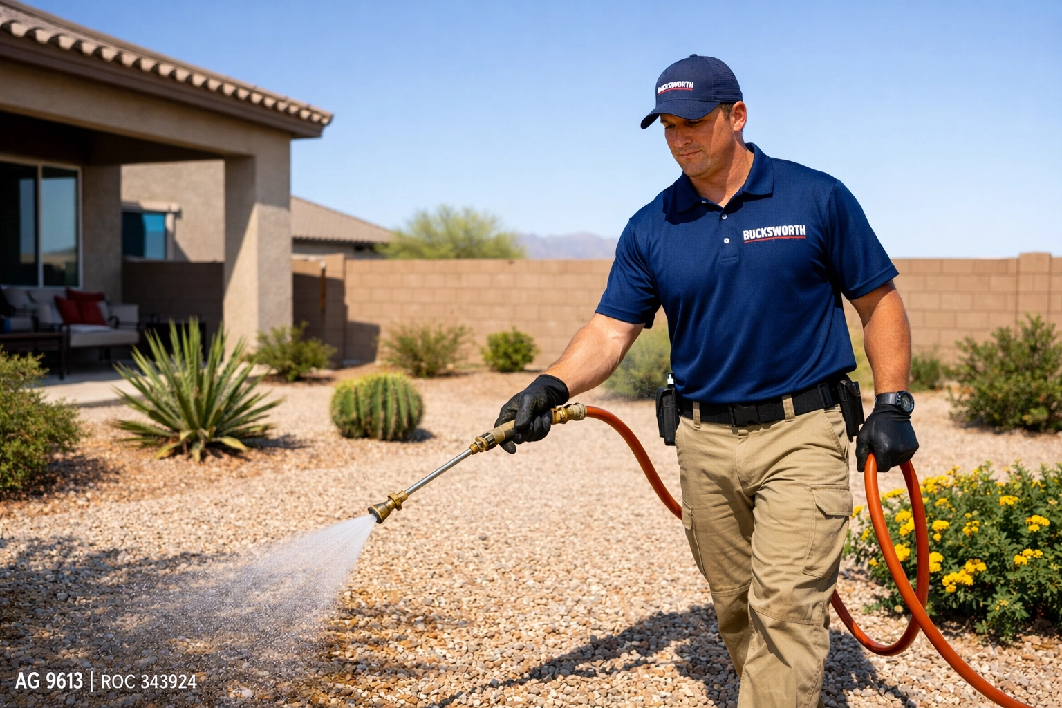 Professional weed control service in El Mirage AZ showing a Bucksworth technician spraying a residential gravel yard.