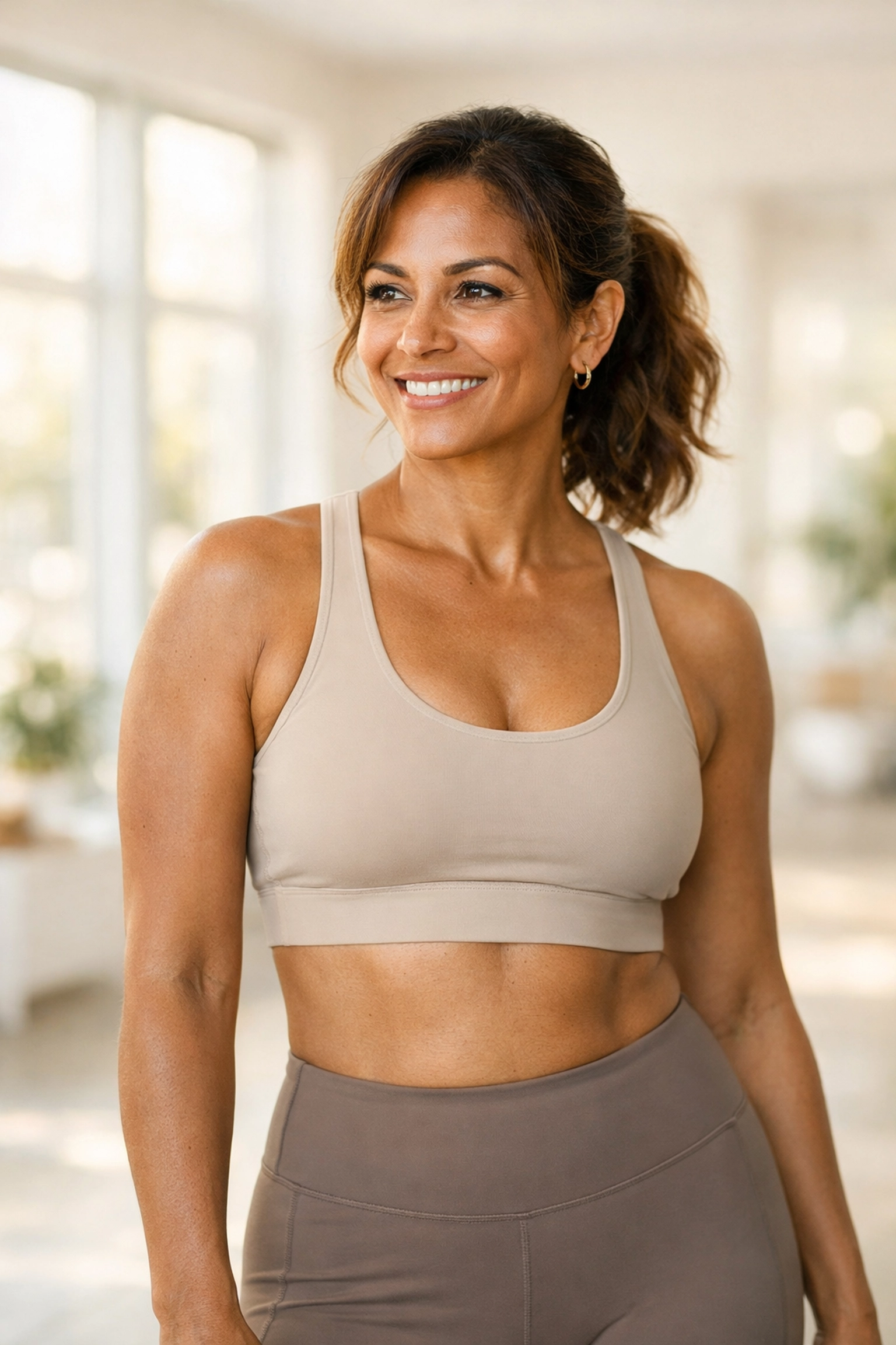 Confident woman in athletic wear reflecting positive results from weight loss therapy.