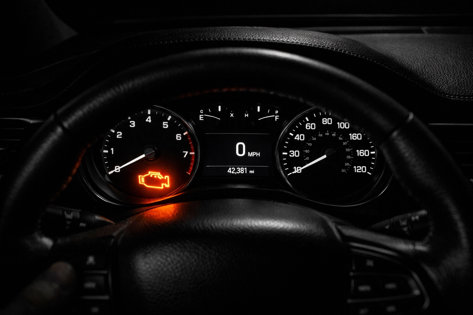 Interior car dashboard view showing an illuminated check engine light requiring professional diagnostic service.