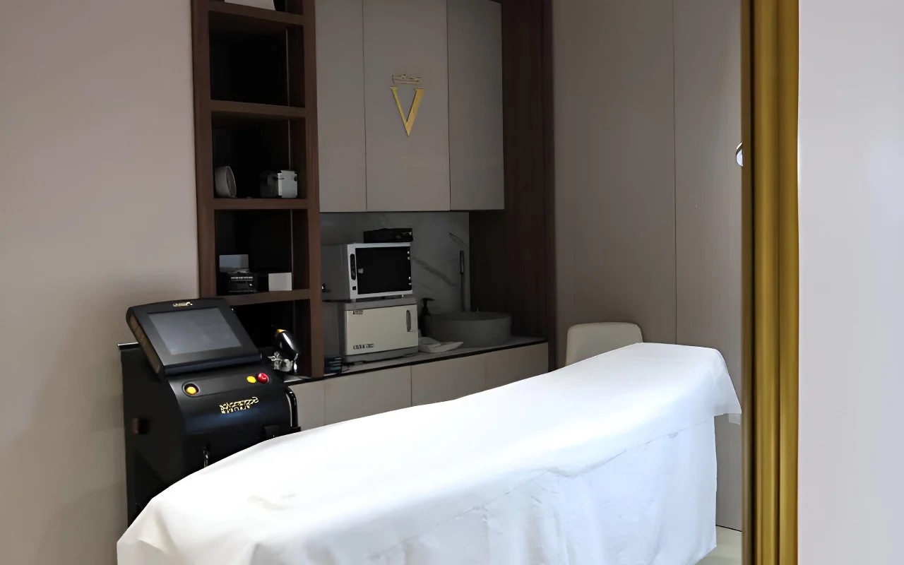 Treatment room featuring a high-tech three-cluster laser hair removal system in a luxurious setting