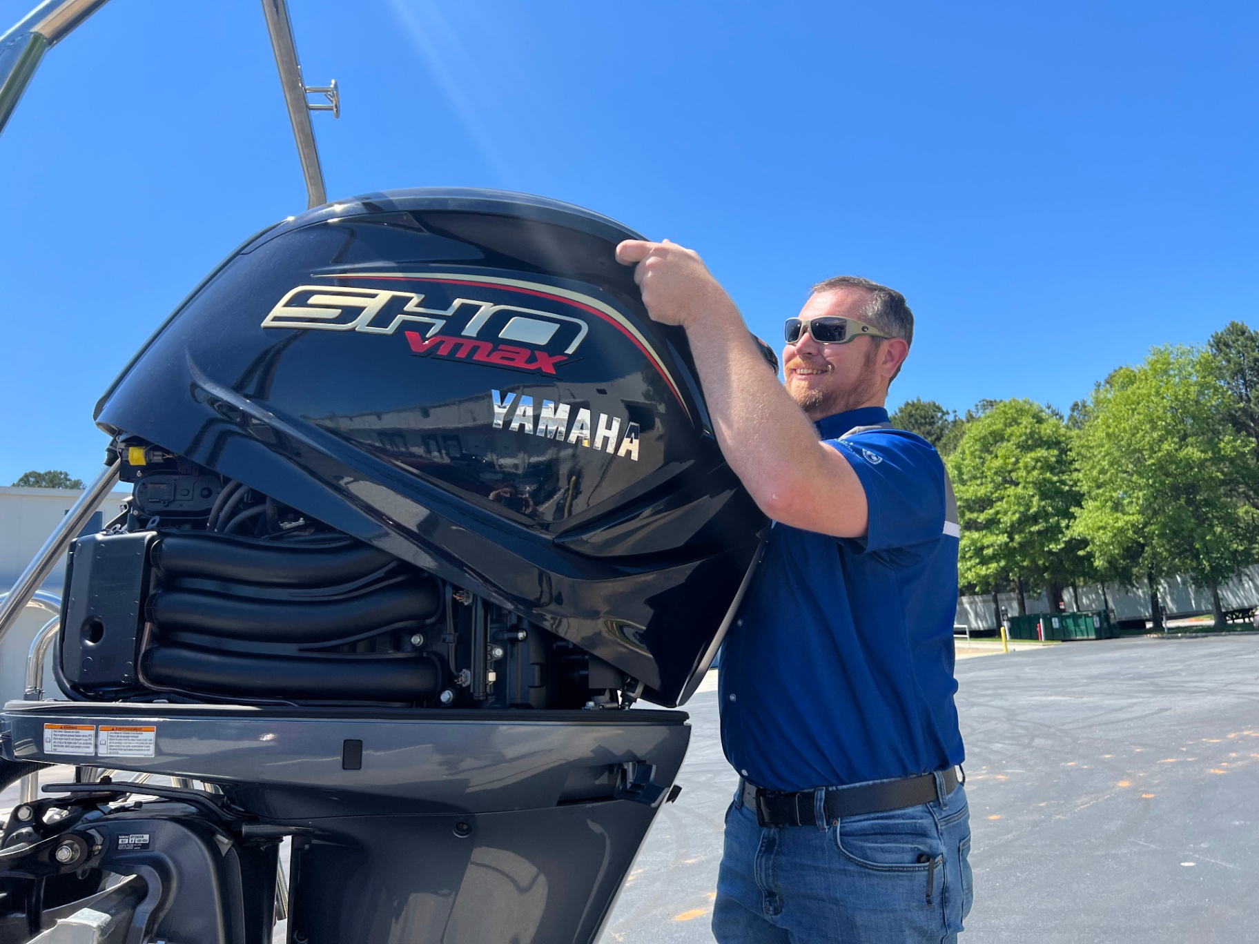 Technician performing maintenance on a Yamaha SHO VMAX outboard motor