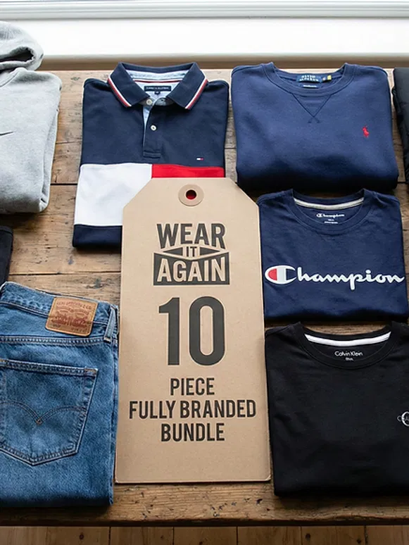 Ten pieces of Grade A/B pre-loved branded clothing, including Champion and Levi’s, neatly folded.