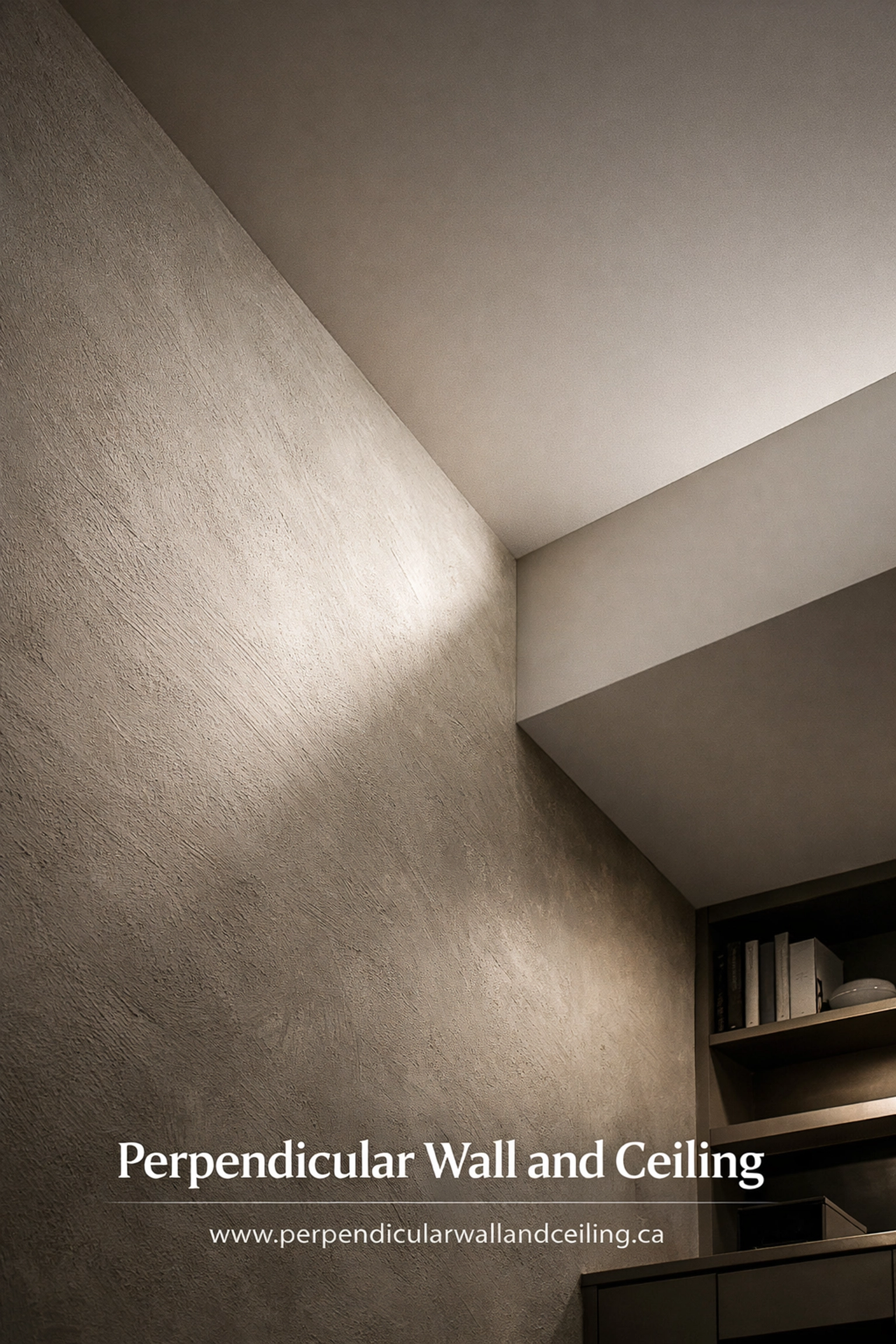 Textured wall meeting smooth ceiling in a modern basement home office with natural lighting