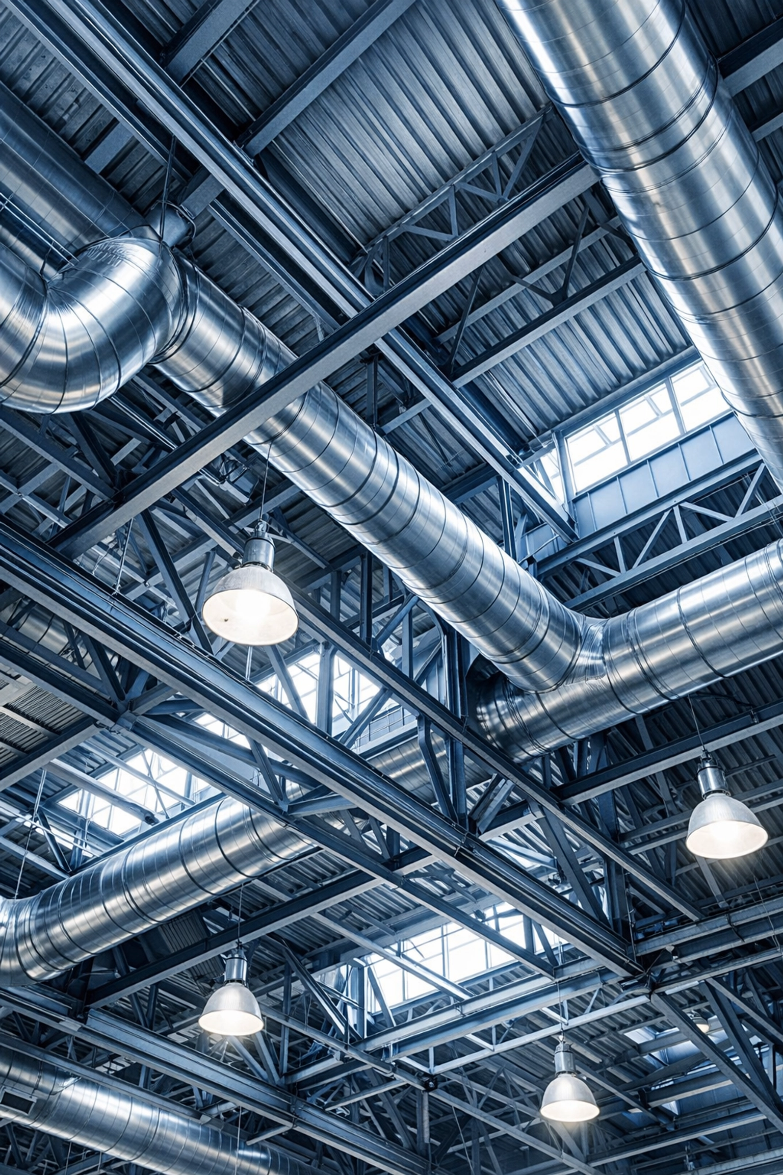 High-level industrial cleaning of ceiling rafters and HVAC ducts in a sterile Massachusetts facility.
