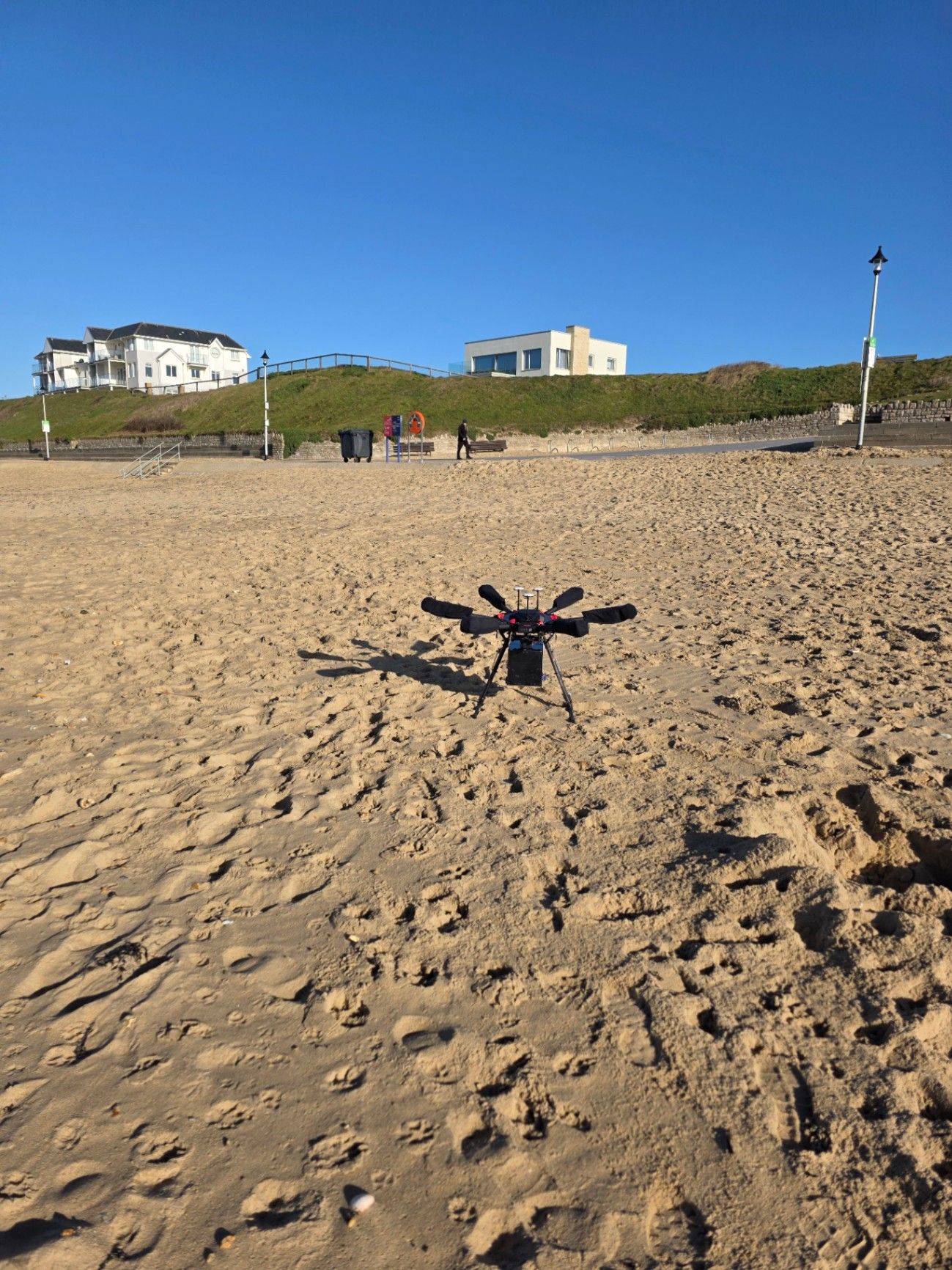 Drone on the beach with dunes and buildings at Southbourne