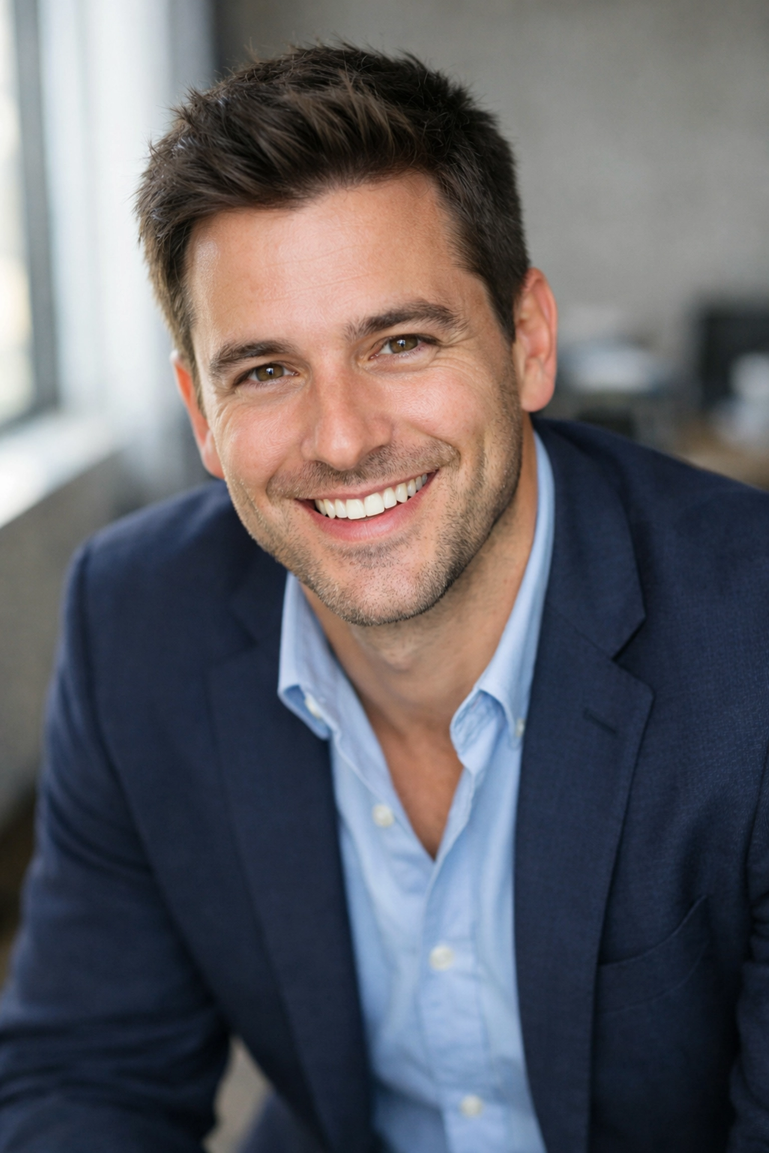 Approachable man with a natural smile demonstrating professional corporate headshot tips for posing.