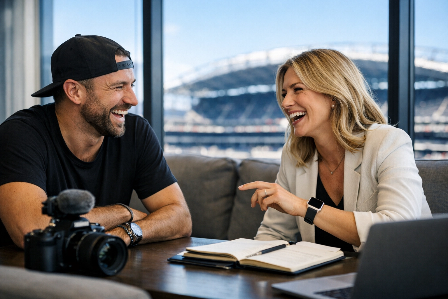 A brand strategist and content creator collaborating on fan engagement ideas with a stadium backdrop.