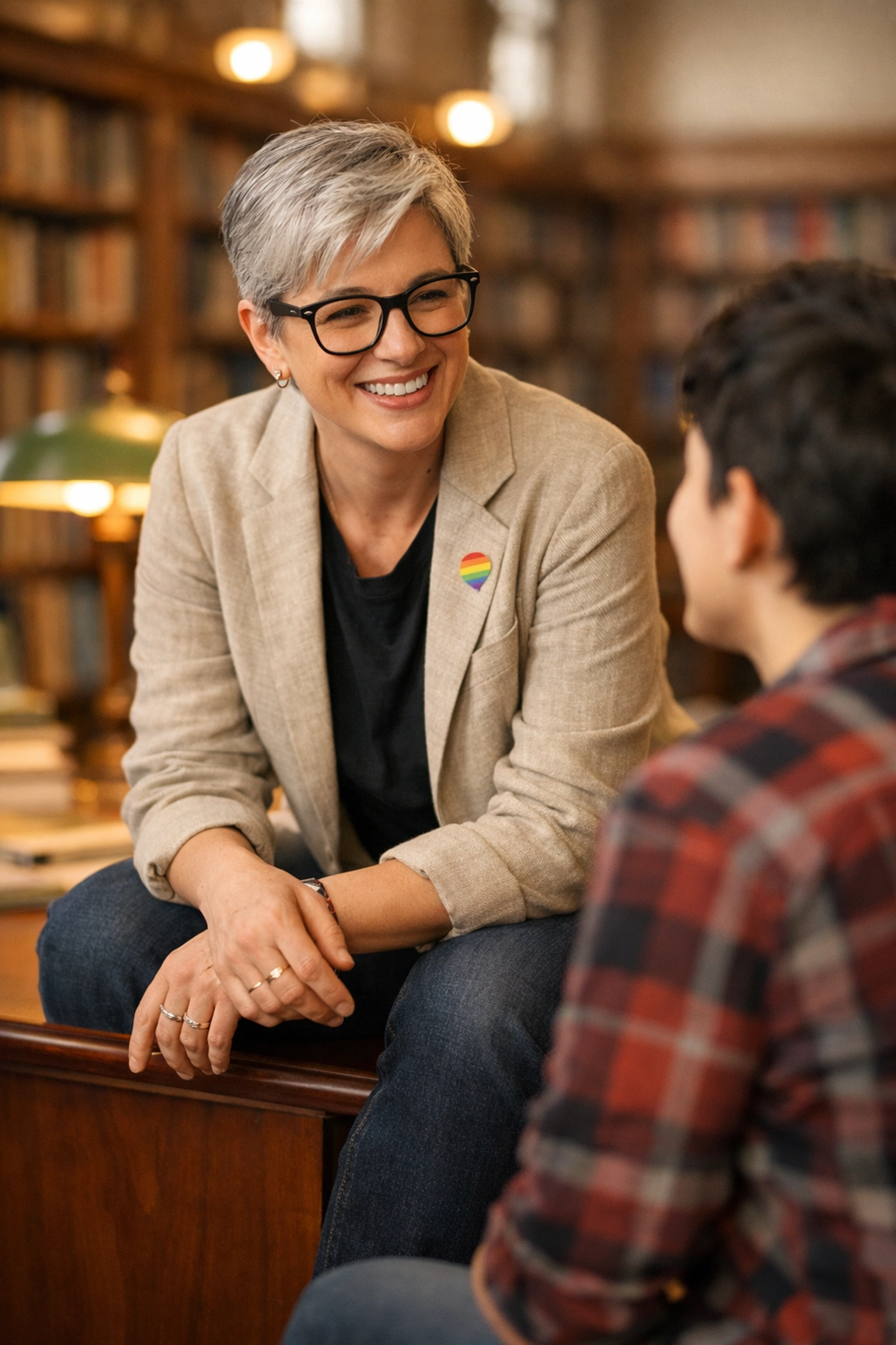 Non-binary educator mentoring a student, symbolizing queer leadership and growth in higher education.