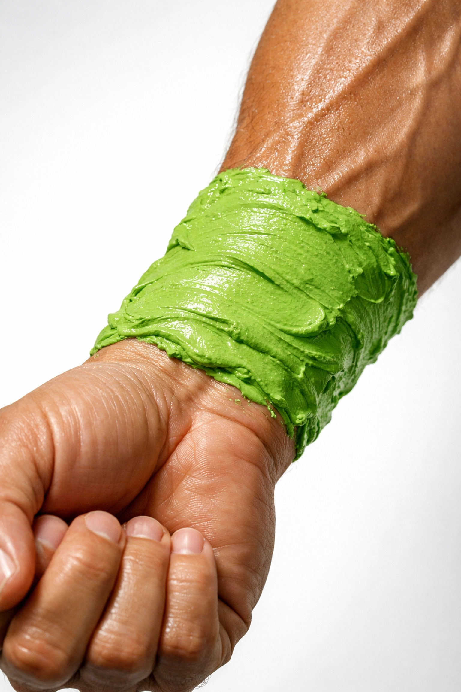 Close-up of green healing clay applied to arm as natural alternative to Biofreeze for recovery