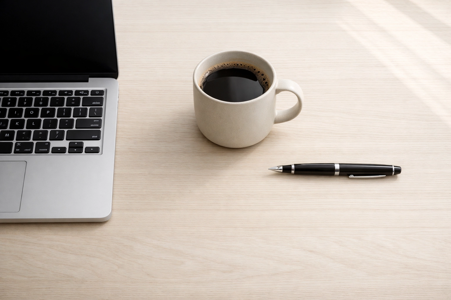 Clean desk with a laptop showing a hotel management platform for real-time data and reporting.
