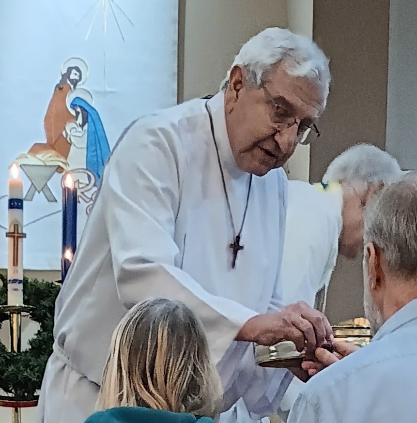 A pastor distributes communion during worship service